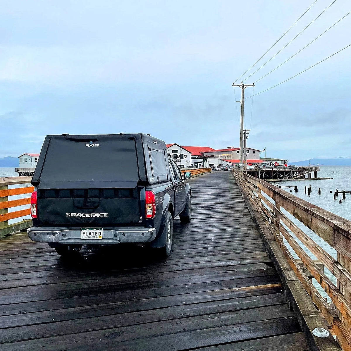 A truck driving on a pier with its Air-Topper™ Mid-Size - GETFLATED